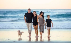 Family on Australian beach with pet dog
